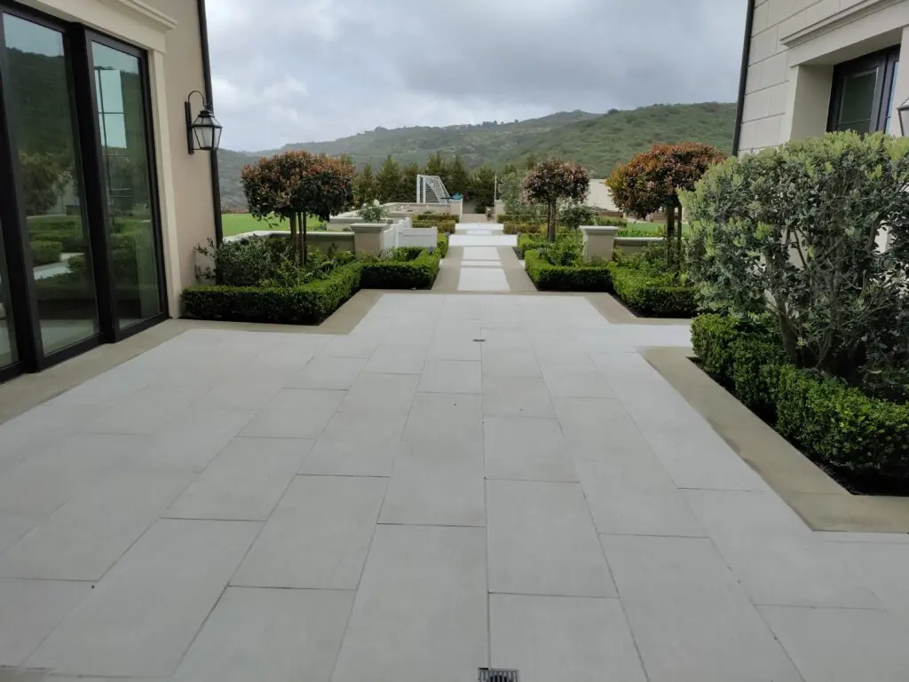 Elegant stone patio with hedges